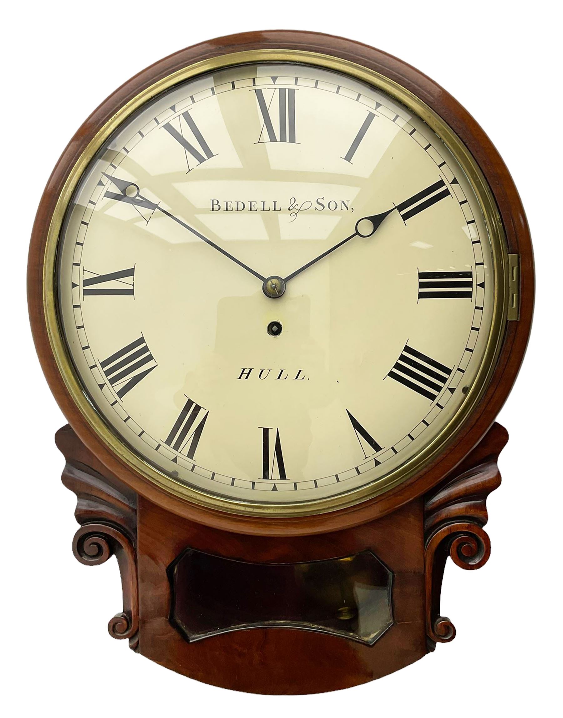 A single fusee 8-day drop dial mahogany cased wall clock, c1860 with a 14-1/2” wooden bezel and 12” painted convex dial, cast brass bezel and convex glass, dial with retailer's name “Bedell & Son, Hull”, Roman numerals, minute track and matching steel moon hands, with a recoil anchor escapement and rectangular movement plates, case with scroll carved ears and glazed pendulum aperture, pendulum location door and a pendulum regulation door to the curved base. With pendulum.
***Peter and Benjamin Bedell were a family of 19th century Hull clockmakers working from various locations in Hull between 1823 and 1872.
