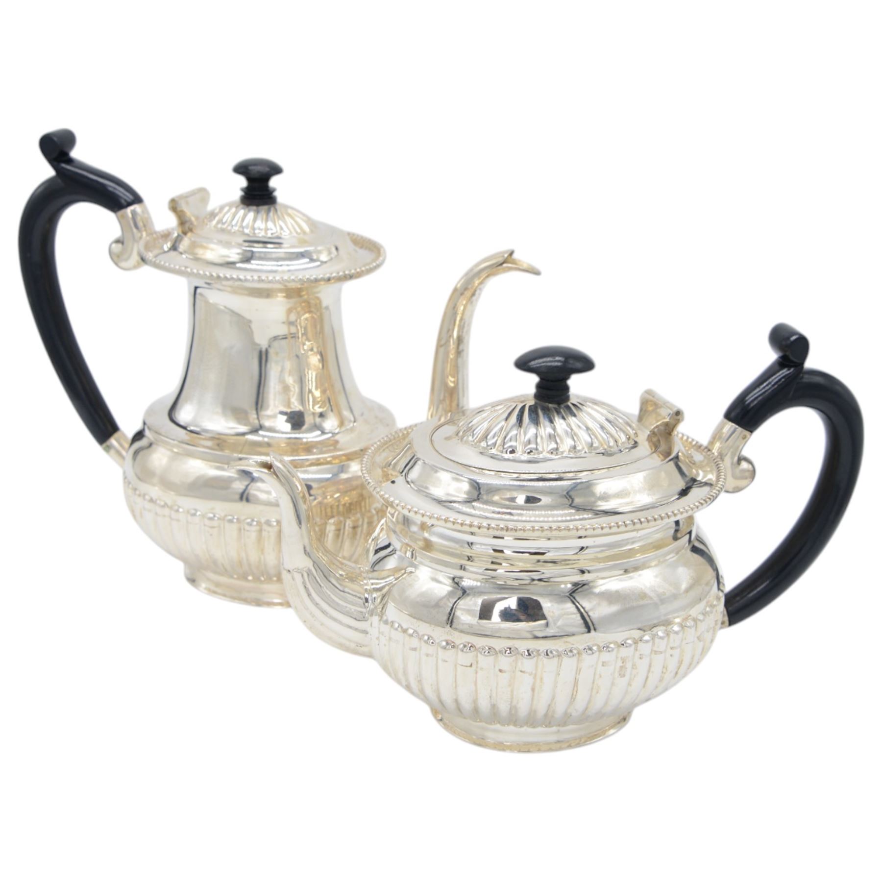 Late 20th century Indian Colonial silver six piece tea and coffee service, comprising coffee pot, hot water pot, teapot, milk jug, open sucrier and tray, all of oval part fluted form, the tea and coffee pot with ebonised wooden handles and finials, stamped SIL and with maker's mark for Cooke & Kelvey New Dehli, within two boxes and with original receipt for 1999