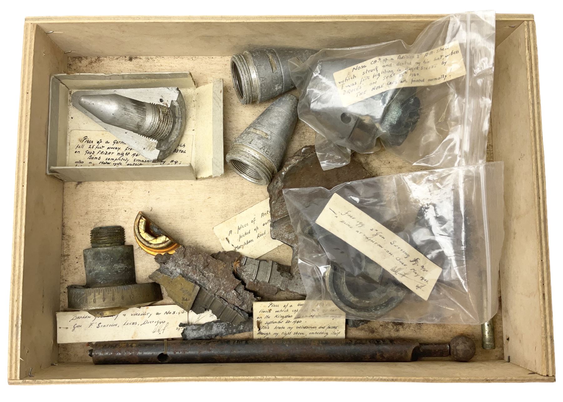 Small collection of WW2 shrapnel and German and British shell parts, most with manuscript details of where and when found including London, Leeds, Bristol, Linton-on-Ouse etc