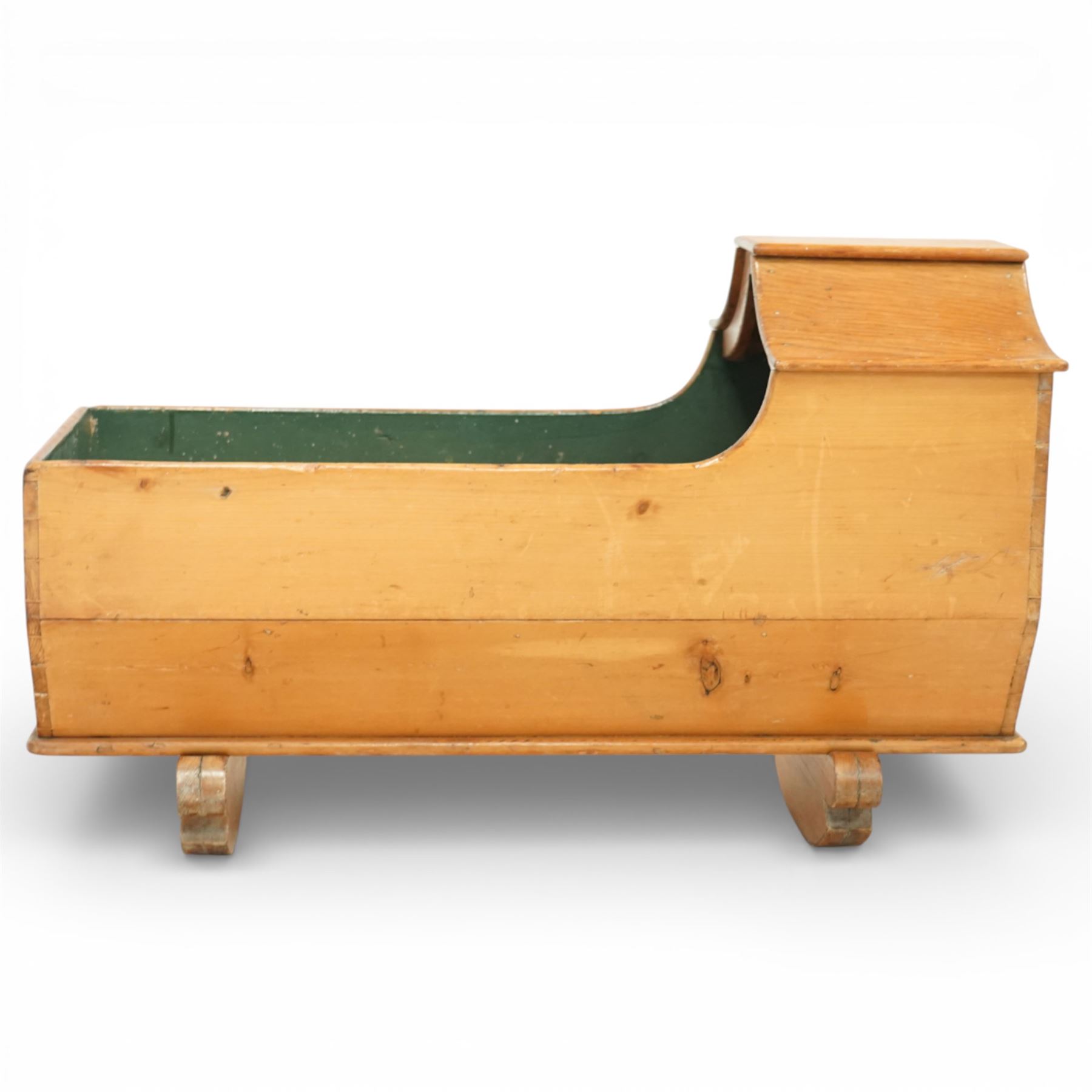 Victorian pine crib, of elongated rectangular form with raised hooded head end, painted interior, panelled sides and raised on a rocker base