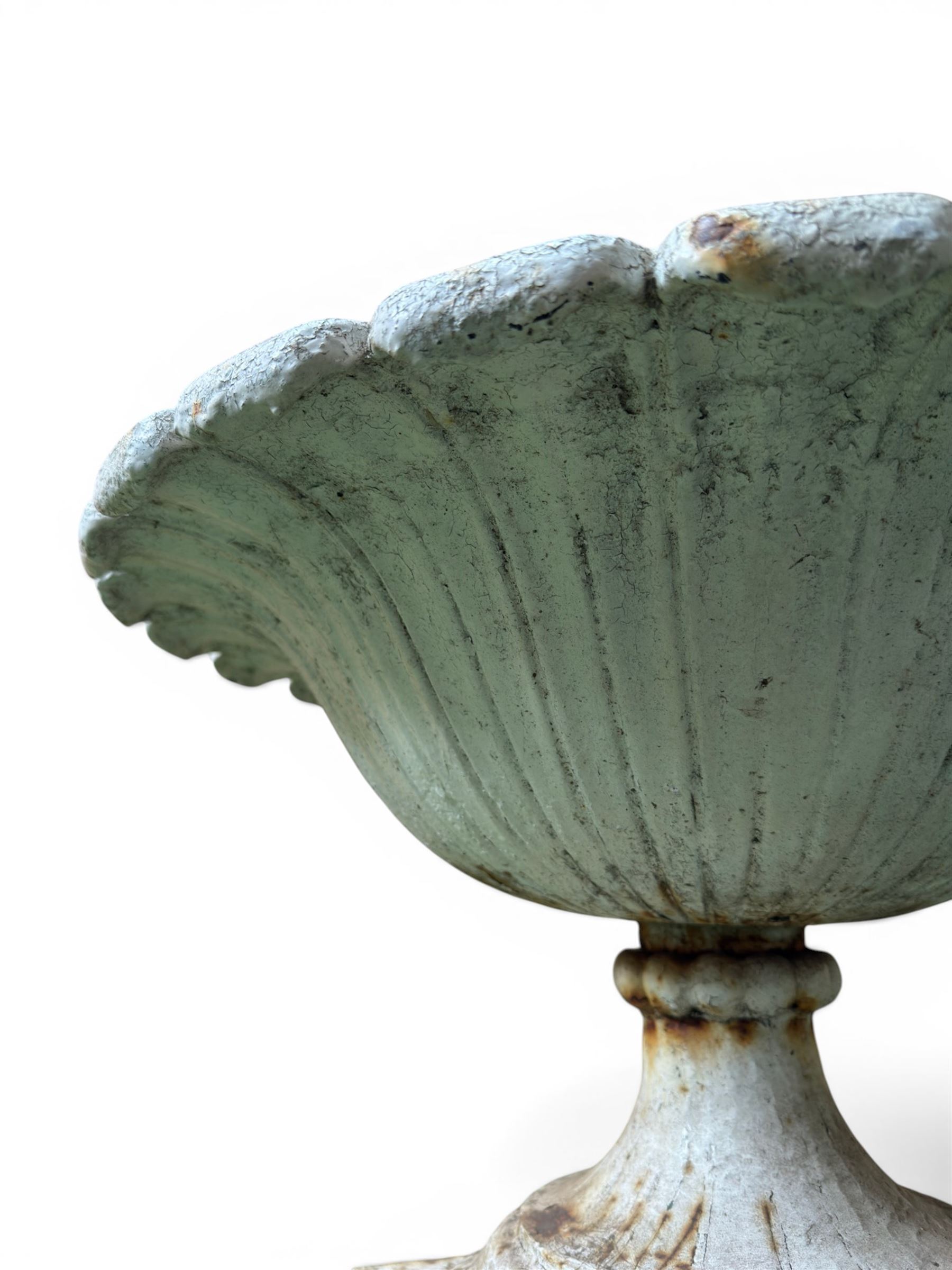 Coalbrookdale - pair of 19th century cast iron petal rim urns, squat form on square plinth, finished in distressed white paint, design registration number 133334, first registered 19 september 1860, number 19 in the Coalbrookdale Castings Catalogue (see illustration)