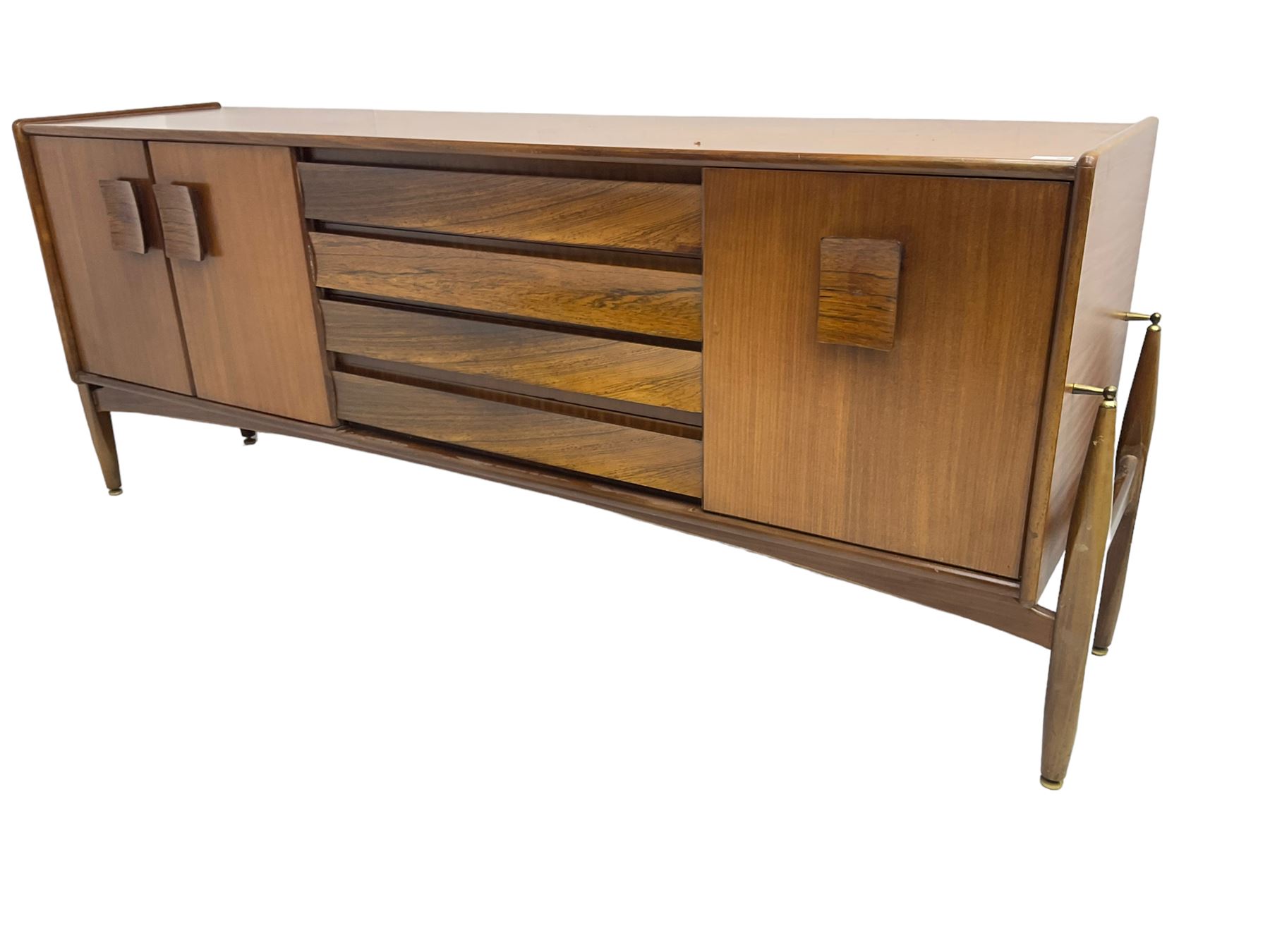 Elliots of Newbury (EoN) - mid-20th century teak sideboard, fitted with four central doors flanked by fall-front cupboard and a double cupboard, each with concave wooden handles
