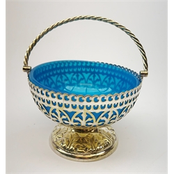  A WMF silver plated Art Nouveau pierced pedestal bowl, of circular form with twin handles, the bowl decorated with flowers and tendrils, stamped WMF, H12cm, together with a silver plated pierced pedestal bowl with swing handle and blue glass liner, and a silver plated epergne.   