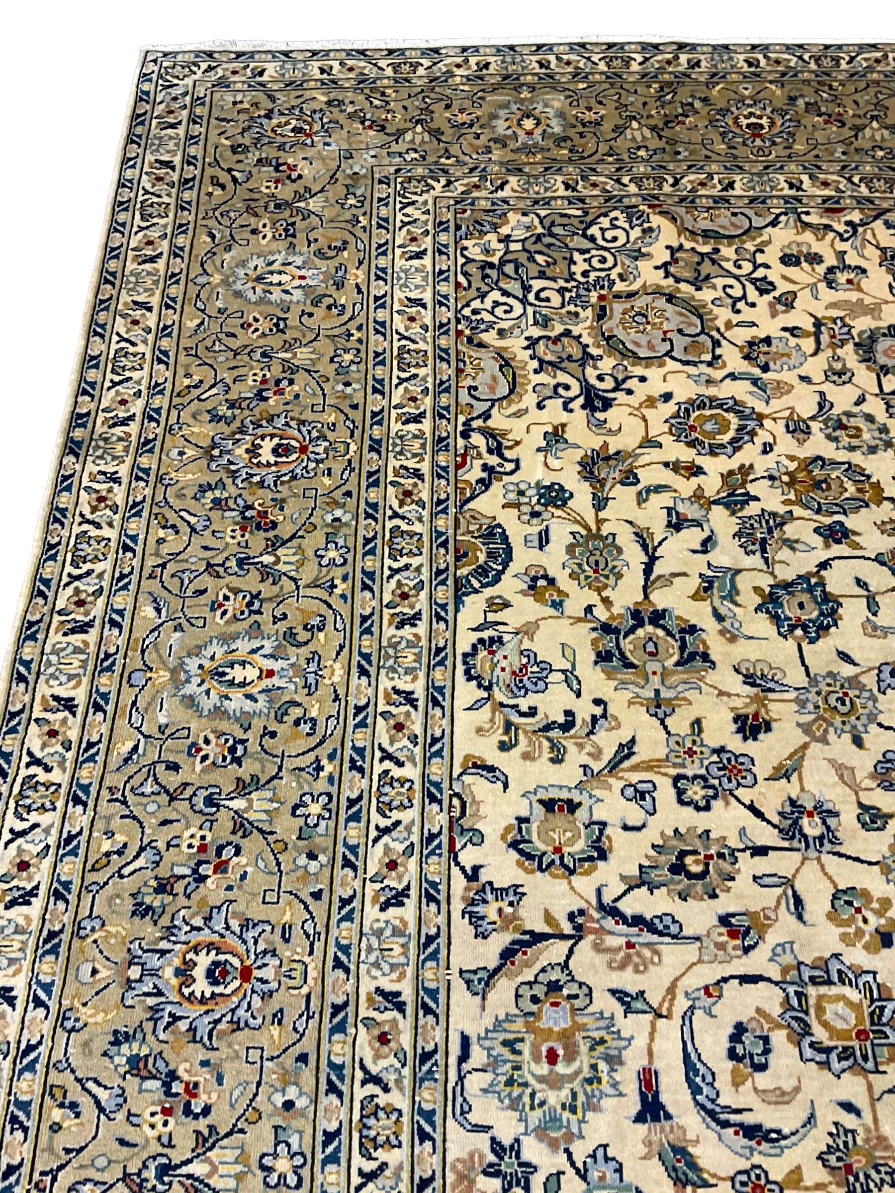 Central Persian Kashan carpet, decorated all-over with interlacing floral design, scrolling border with stylised plant motifs, with signed panel