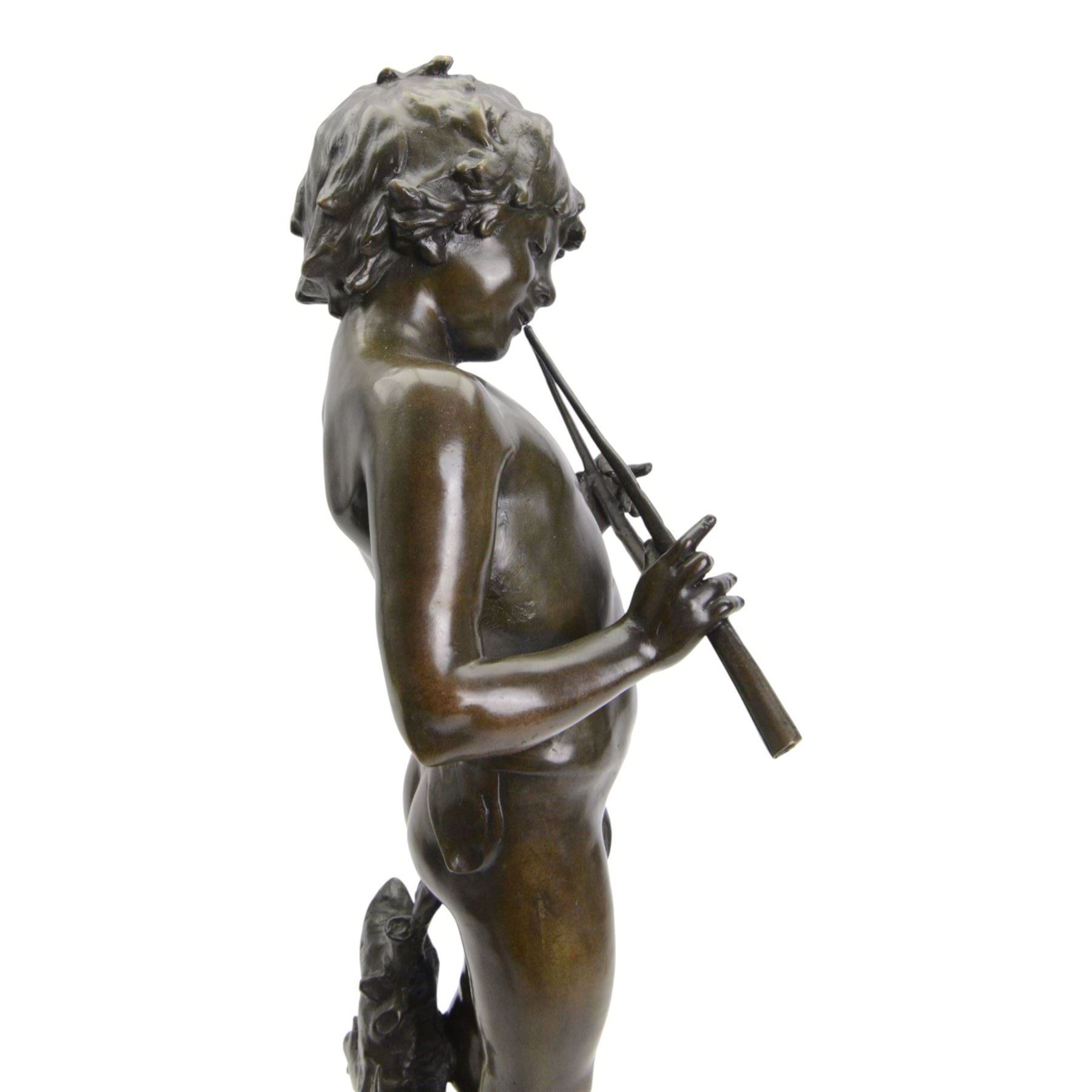 After Auguste Moreau (French 1834-1917): Large Bronze Figure of a Young Boy Playing the Aulos (Double-Reeded Pipes) standing upon a naturalistically modelled base detailed with tree stump and further pipe, signed Aug Moreau, upon octagonal red marble base, H73cm