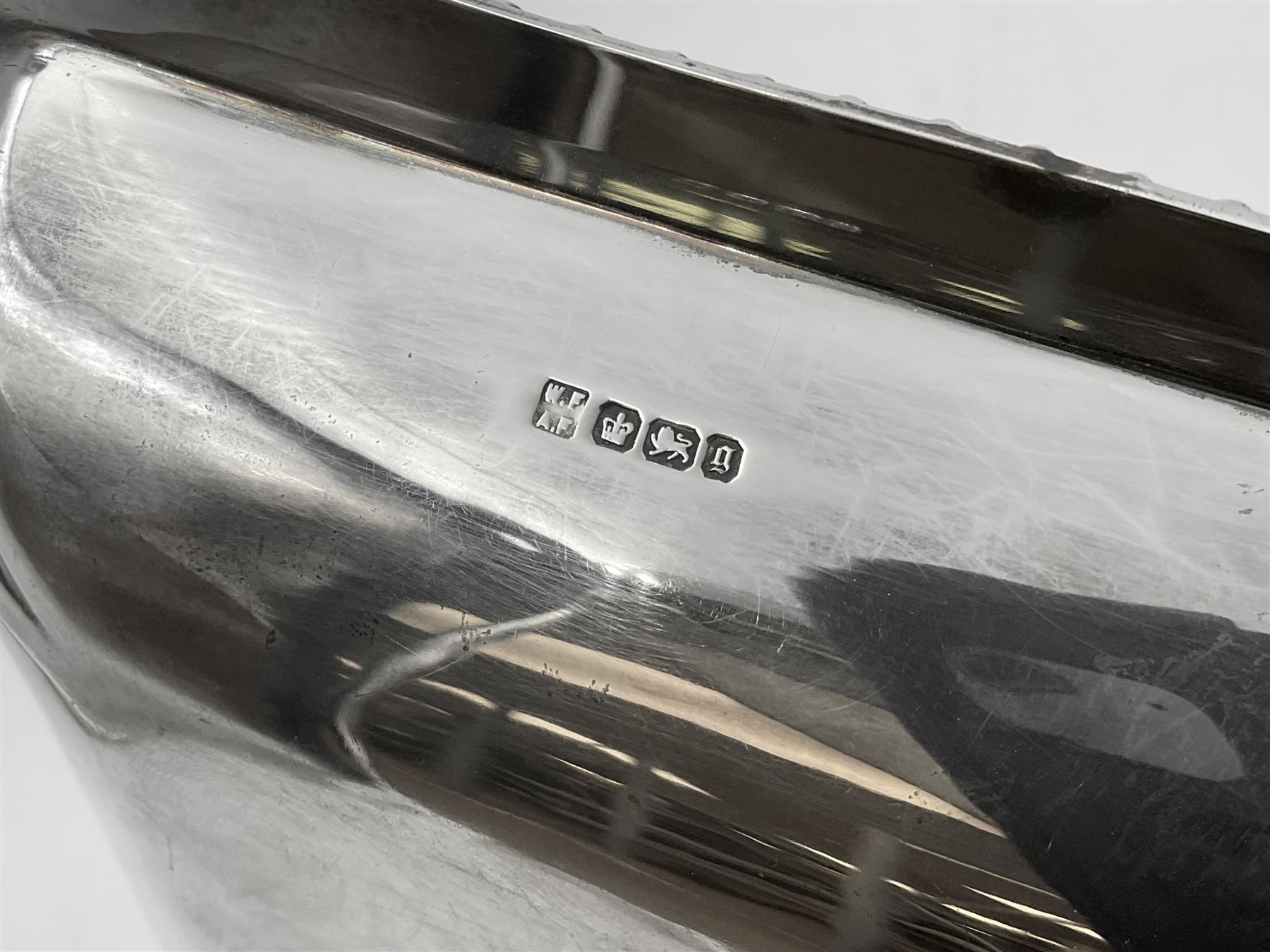 Early 20th century silver entree dish and cover, of rectangular form with shaped corners and oblique gadrooned borders to base and cover, the cover with loop 'bamboo' handle, hallmarked Thomas Bradbury & Sons Ltd, Sheffield 1930, including handle H10.5cm L24.5cm