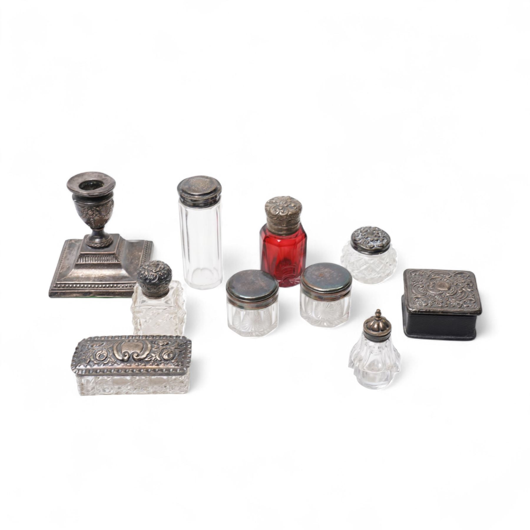 Various silver topped glass dressing table jars, scent flask and a silver dressing table candlestick 
