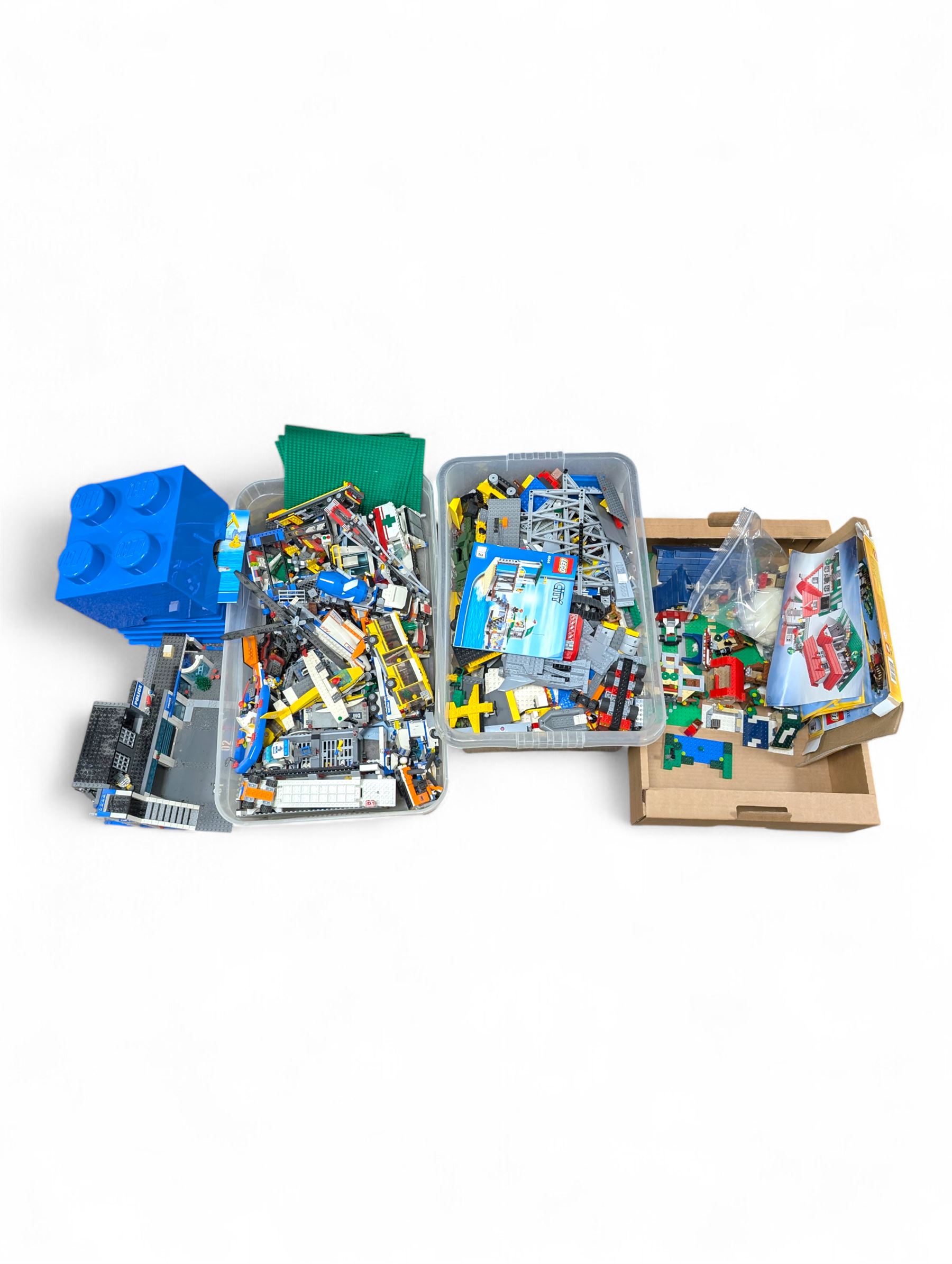 Large collection of Lego, including partially built vehicles, Police Station, Lego Creator 31010 and a collection of Lego instruction booklets