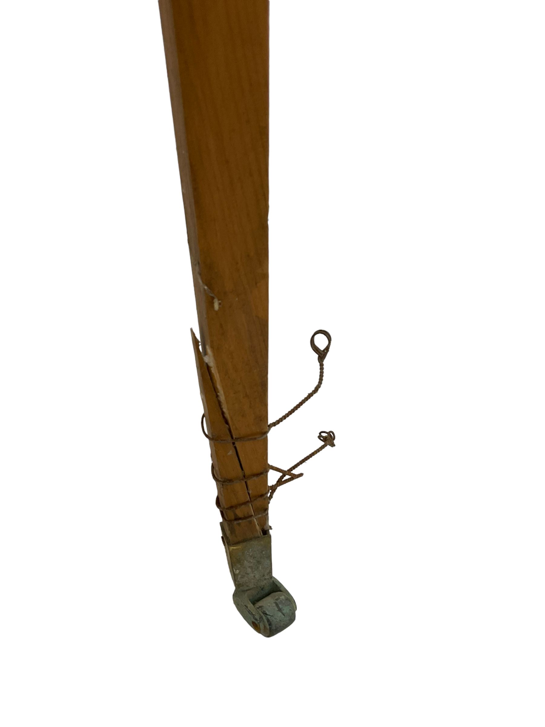 20th century pine architectural collector's cabinet on stand, projecting dentil cornice over various compartments, central recessed arch with turned pillar supports and sloped arch pediment, fitted with four cupboards, false brickwork uprights to front and corners, central hidden drawer revealing cube work surface, lower moulded plinth, the stand with foliate carved mouldings, on six square tapering supports with brass castors