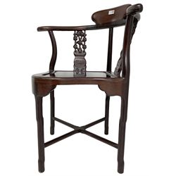 Chinese carved hardwood corner chair, outswept arms over pierced and carved floral splats, raised on shaped cylindrical supports united by X-stretcher