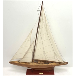 Bespoke Oak Furniture model of a 1930s J Class Americas Cup Challenger sailing yacht with mahogany hull, simulated planked deck with various fittings and three sails, on integral stand with plaque 'Endeavour 1934' and maker's stamp L99cm H121cm