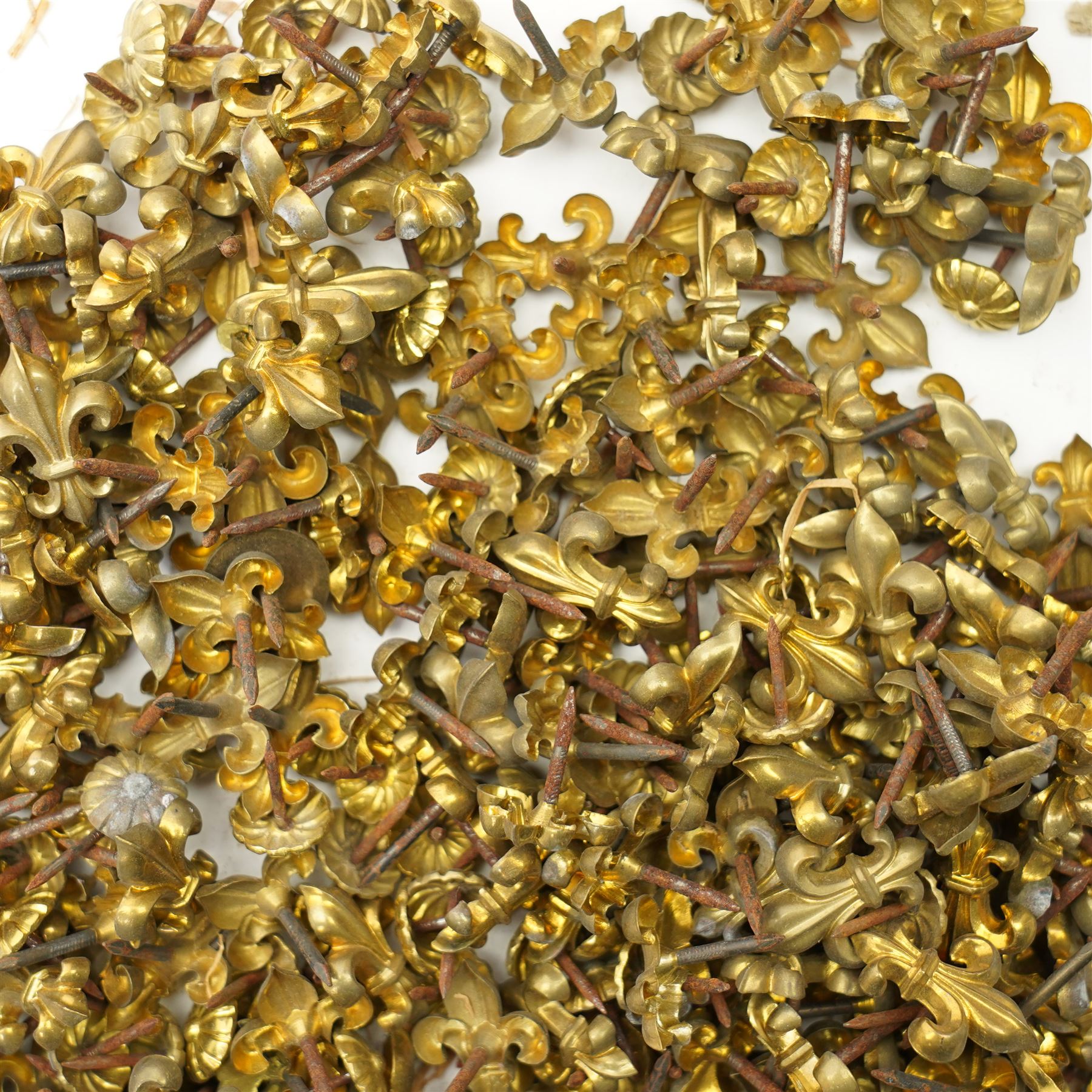 Large quantity of Victorian brass upholstery pins with rosette and fleur de lis designs 
Provenance: property of a Nobleman