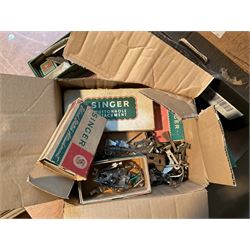 Two Singer sewing machines, model numbers 527 and 457, together with various Singer sewing machine parts, and a selection of sewing related accessories, to include threads, sewing needles, etc.