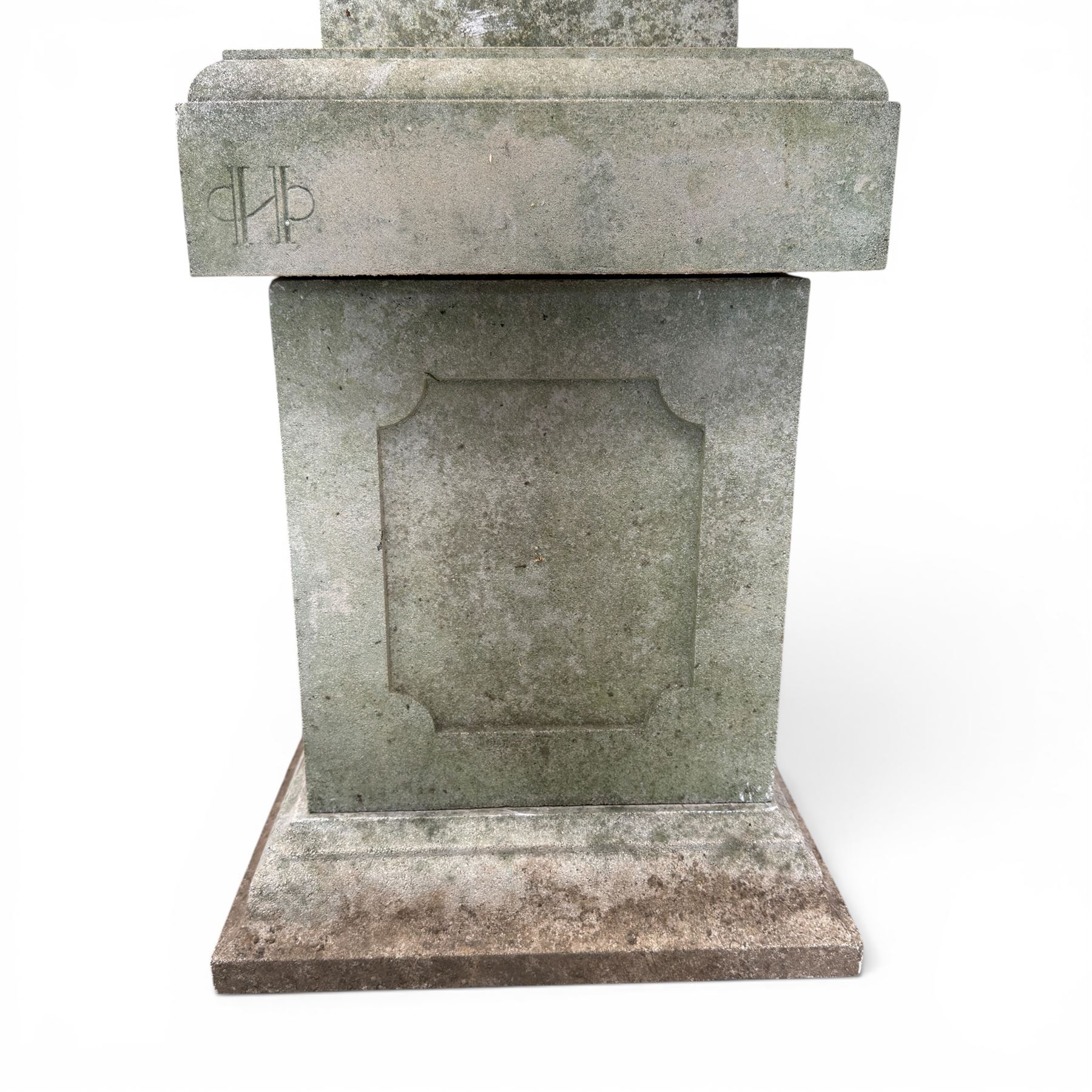 Pair of weathered cast stone Neoclassical design garden Kylix shape urns, foliate moulded rim over a gadrooned underbelly, the scalloped socle over a rectangular pedestal with faux-panelled sides, stamped with stylised ‘H’ monogram