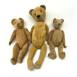 Early 20th century American wood wool filled short bristle mohair long bodied teddy bear with swivel jointed head, boot button eyes and vertically stitched nose and mouth and jointed limbs H23