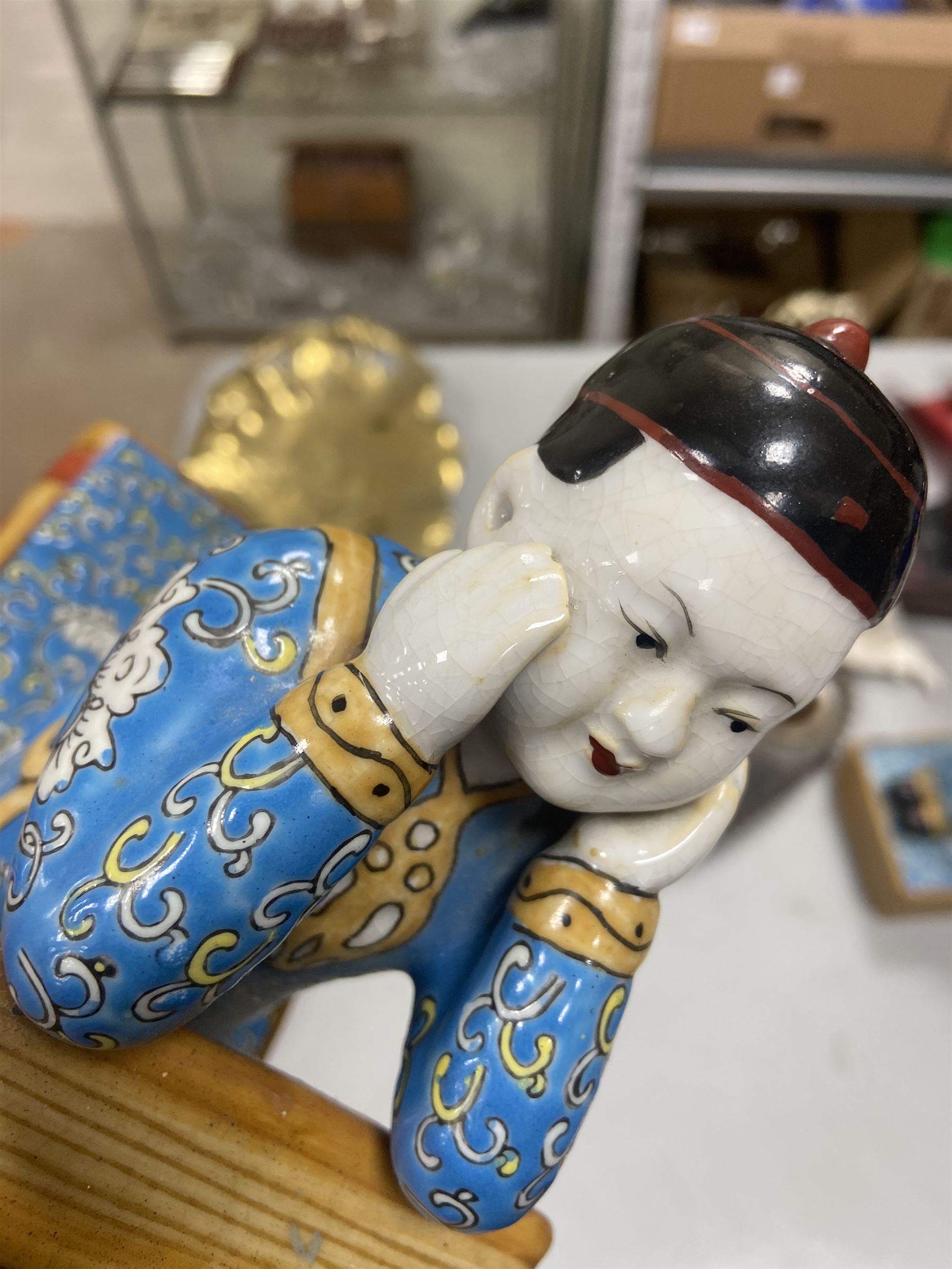 Pair of 20th century Chinese figural bookends, modelled as children in traditional blue dress sat reading and kneeling upon stacks of books, H22cm