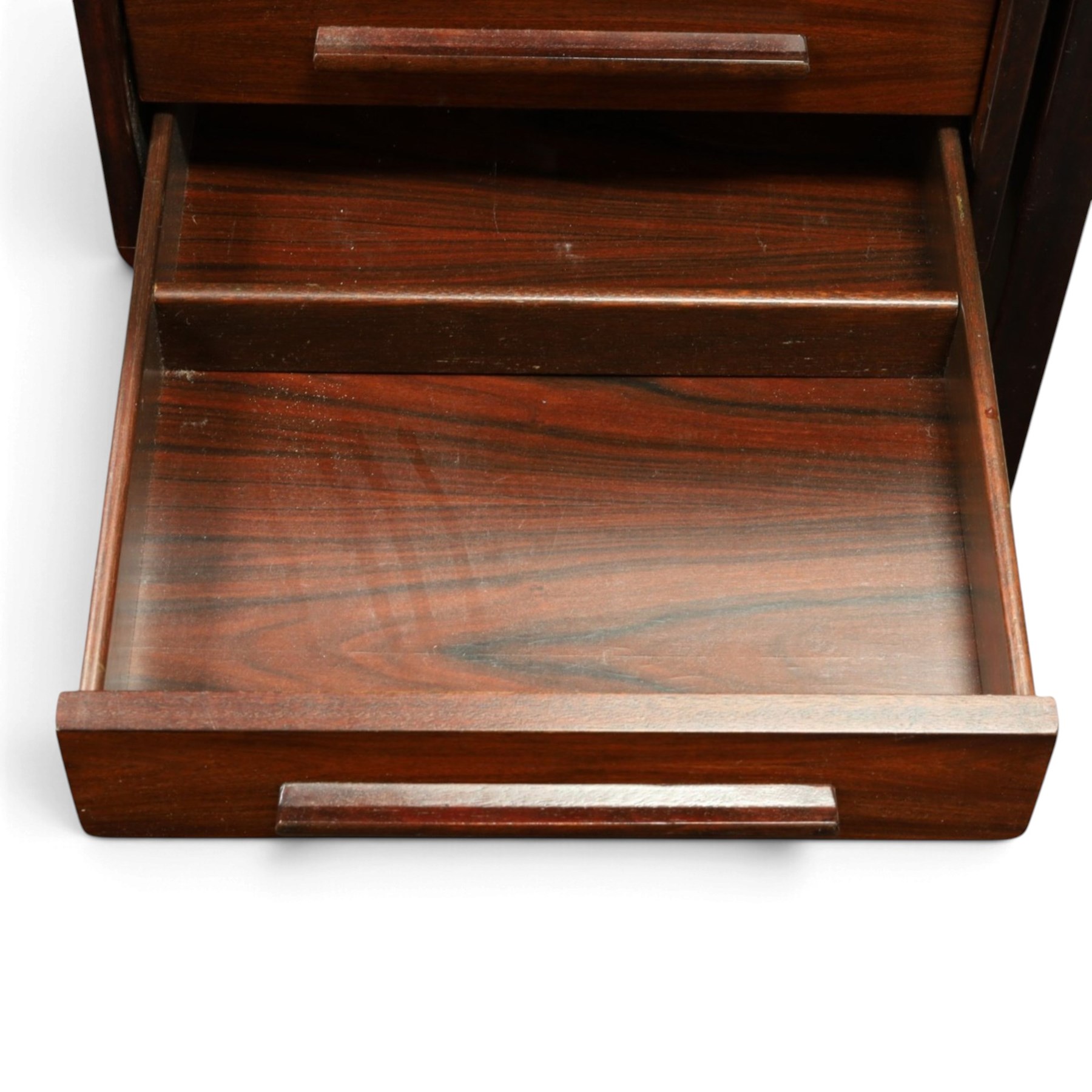 Dyrlund - Santos rosewood office suite, comprising an executive desk and cream leather upholstered swivel chair, the desk with a broad rectangular top with rounded corners, leather writing surface, pen compartments and letter tray, three lockable frieze drawers with fitted interiors above a central kneehole flanked by floating drawer pedestals, the left housing a filing drawer and the right three compartmented drawers, with a full width modesty panel to the reverse, chair raised on a castor base, H 116cm, W 62cm, D 74cm