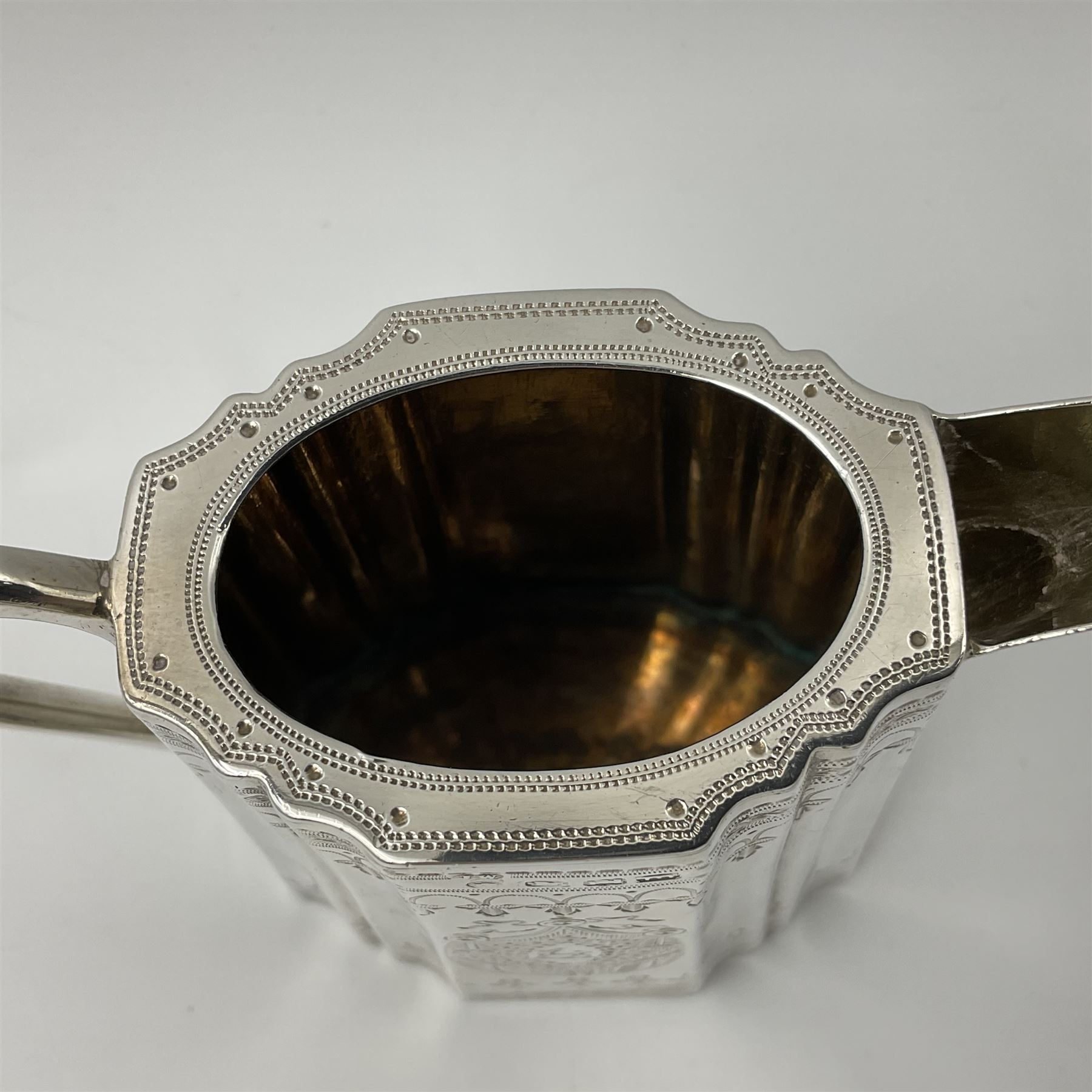 Victorian three-piece silver tea service, comprising teapot, twin handled open sucrier and milk jug, of oval form with shaped rim and C handles, each engraved with crests and bands of strapwork decoration, the milk jug and sucrier with gilt interiors, hallmarked Josiah Williams & Co, Exeter 1881, the teapot with ivory insulators and finial, all contained with a tooled leather, blue silk and velvet lined fitted case, retailed by West & Sun, Dublin 
This item has been registered for sale under Section 10 of the APHA Ivory Act