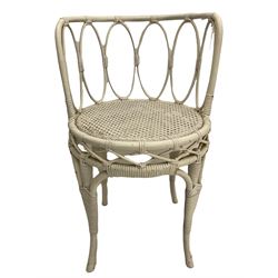 French style painted beech open armchair, with caned seat and back, carved with flower heads, cabriole supports (W58cm), and a cane work side chair