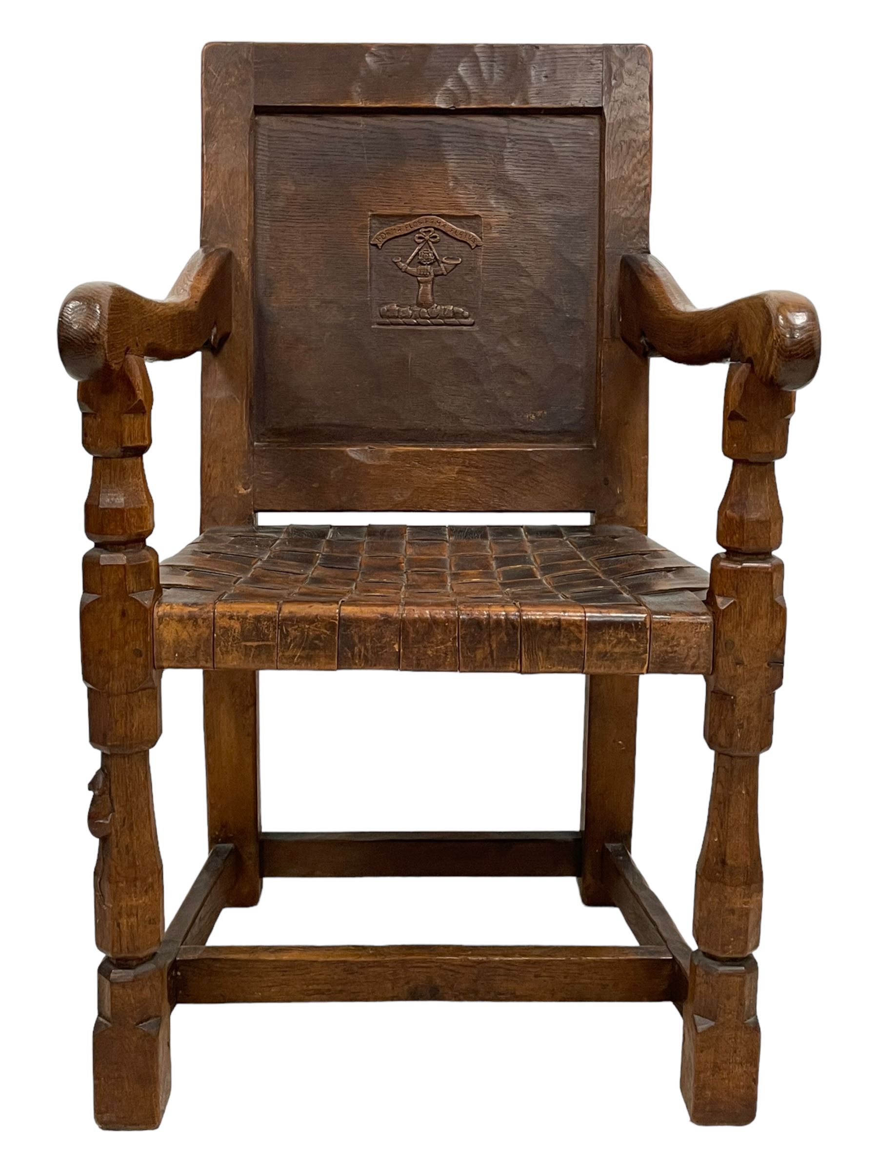 Mouseman - circa. 1930s set of six (4+2) oak dining chairs, panelled back carved with the Bagshawe family crest, the moto 'Forma Flos Fama Flatus' over an arm grasping a bugle-horn with ribbon tie and Yorkshire rose motif, adzed frame, leather lattice strap seat, on octagonal supports united by stretchers, two carvers and four side chairs, each carved with mouse signature, by Robert Thompson of Kilburn 

Provenance: Owned since manufacture by the Bagshawe family, descendants of the Staithes Group Artist Joseph Richard Bagshawe RBA (1870-1909).
