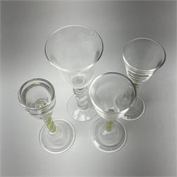 Six late 20th century Paul Manson Shilbottle Glass Studio drinking glasses, comprising three examples with multi series colour twist stems and pronounced domed and folded feet, an example with double series opaque twist stem, and two examples with multi knopped stems, each signed beneath. 