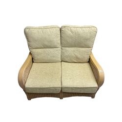 Contemporary rattan conservatory suite - two seat sofa with wicker frame and loose cushions upholstered in textured champagne fabric (W125cm H98cm); pair of matching armchairs (W72cm H98cm); rectangular glass-topped coffee table with rattan frame and undertier (W85cm D60cm H47cm); and matching square side table (W53cm H55cm)