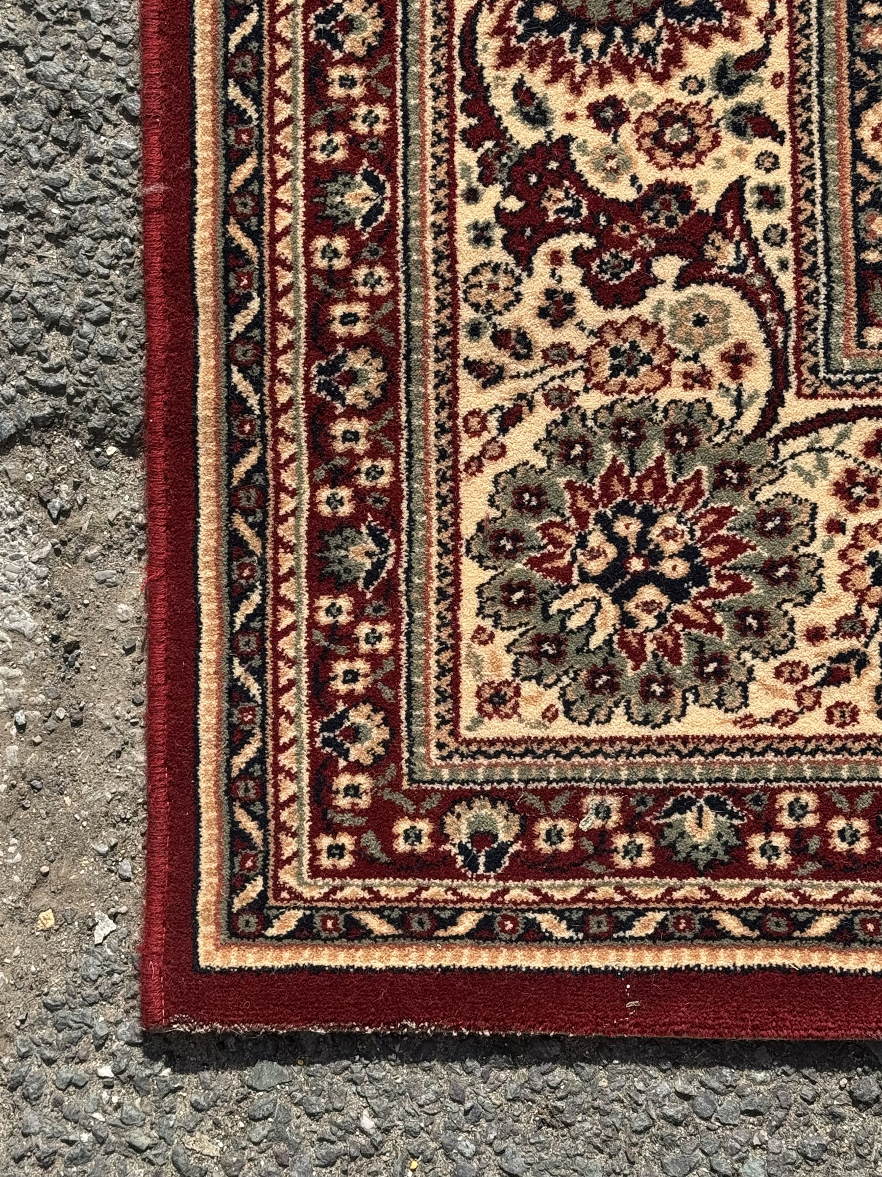 Royal Kashmir worsted wool modern Persian design area rug, with crimson field and stylised rosette patterning throughout, surrounded by wide multi-band border incorporating cartouche and lotus flower motifs