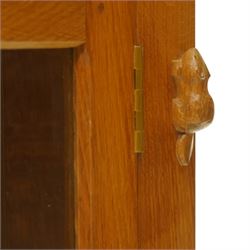 Beaverman - oak hanging corner cabinet, astragal glazed door with a Yorkshire Rose door pull, revealing two fixed shelves, brass mounts for hanging, with carved beaver signature, by Colin Almack of Sutton near Thirsk