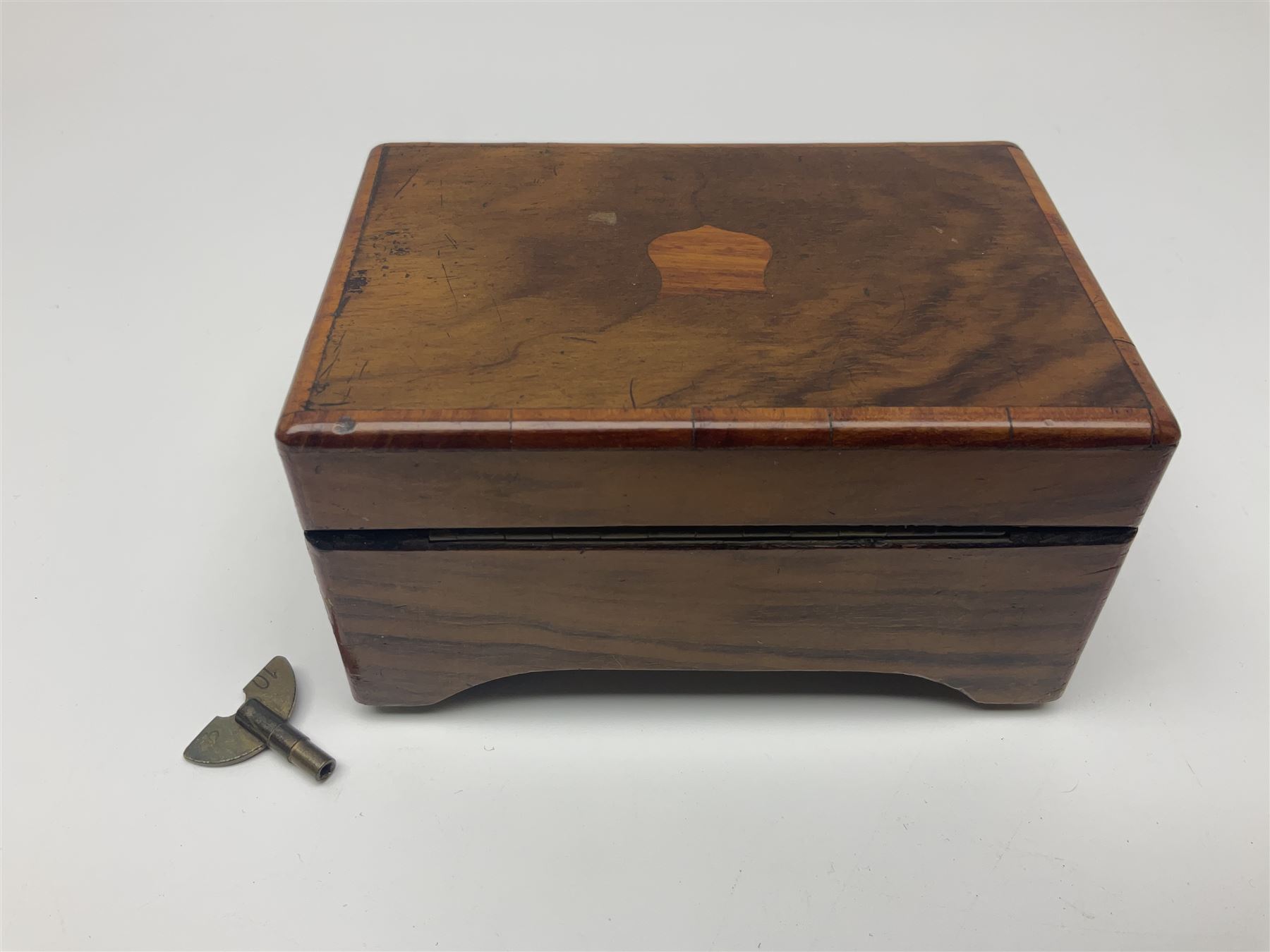 Small late 19th/early 20th century Swiss walnut cased musical box, the overglazed movement with 5cm cylinder and thirty-five tooth comb; the lid with card inscribed 'La Fauvette Salse' and 'Marche de Faust'; under base winding with key; serial no.50443, L12cm