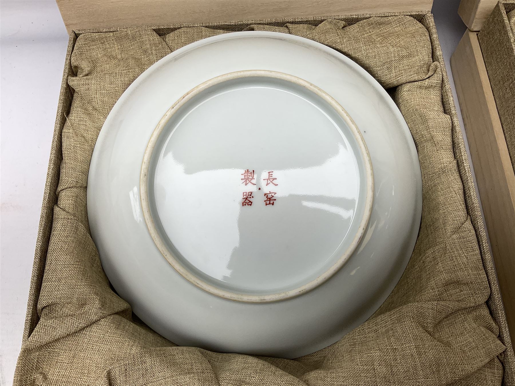 Three Chinese polychrome enamel plates each decorated with floral decoration, all marked beneath, D21cm 