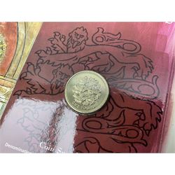 The Royal Mint United Kingdom 1984 brilliant uncirculated coin collection, 1997 and 2001 commemorative crown coins, 1997 old round one pound, all in card folders and four sterling silver medallic first day covers from the 'Great Britons' collection housed in a blue folder