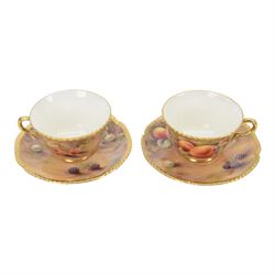 Two Royal Worcester fruit painted scallop edge teacups and saucers, the exterior and sauce...