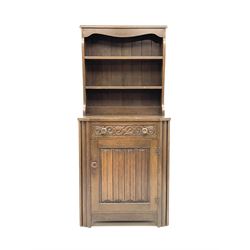 Early 20th century oak dresser with linenfold panelled door and carved drawer front, stile supports