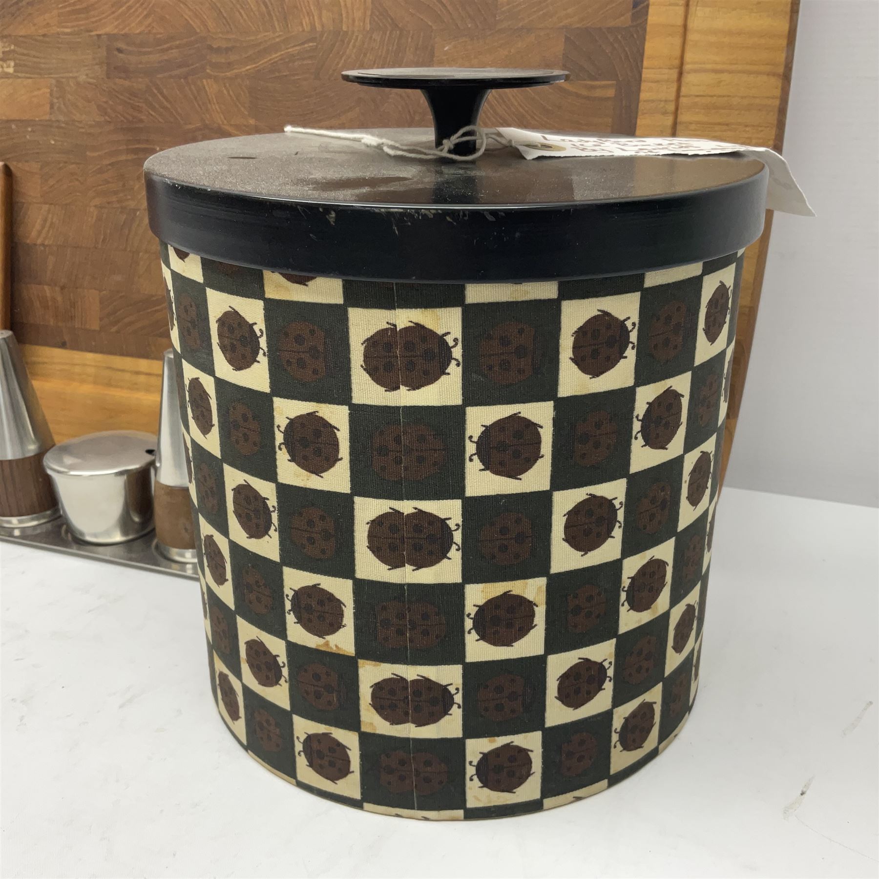 Danish collectables, to include teak tray by Nissen Denmark, ladybird pattern biscuit barrel by Laurids Lonborg and a Stelton stainless steel and wooden cruet set, together with a mid century floral tile trivet