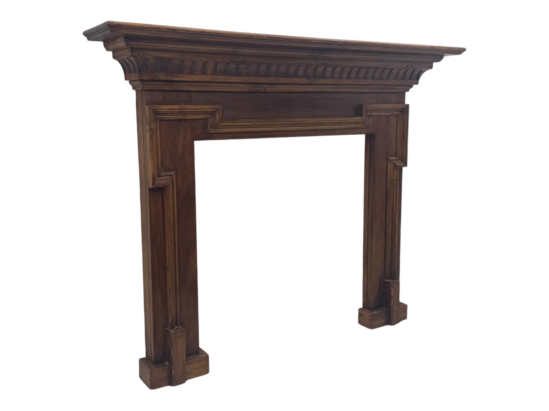 Victorian stained pine fire surround, projecting cornice with dentil moulding, panelled frieze and chamfered uprights on block supports