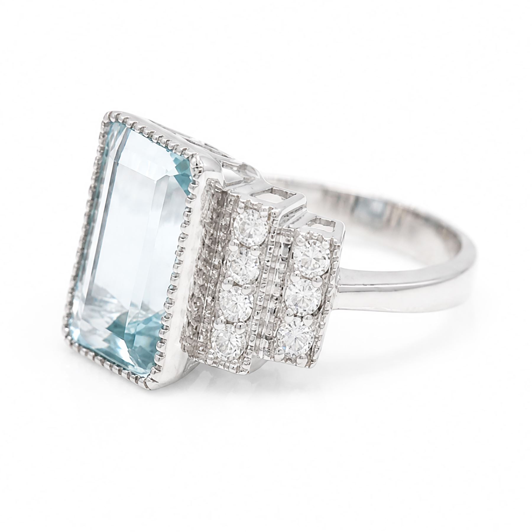 18ct white gold aquamarine and diamond stepped design ring, single milgrain set octagonal cut aquamarine of approx 7.00 carat, with seven round brilliant cut diamonds set either side, stamped 750, total diamond weight approx 0.40 carat