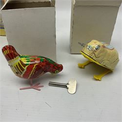 Twenty six tinplate models to include Ferris Wheel and Performing Circus Elephant, marked JW, further similar examples such as Duck on a Bike, Clown on Roller, Carousel; Popeye Tin Speedboat; Looney Tunes Wind Up Cars and Express Train; various international examples, MS107 Jumping Bambi, Pop Pop Boat, jumping frogs, pecking chickens etc; both boxed and loose