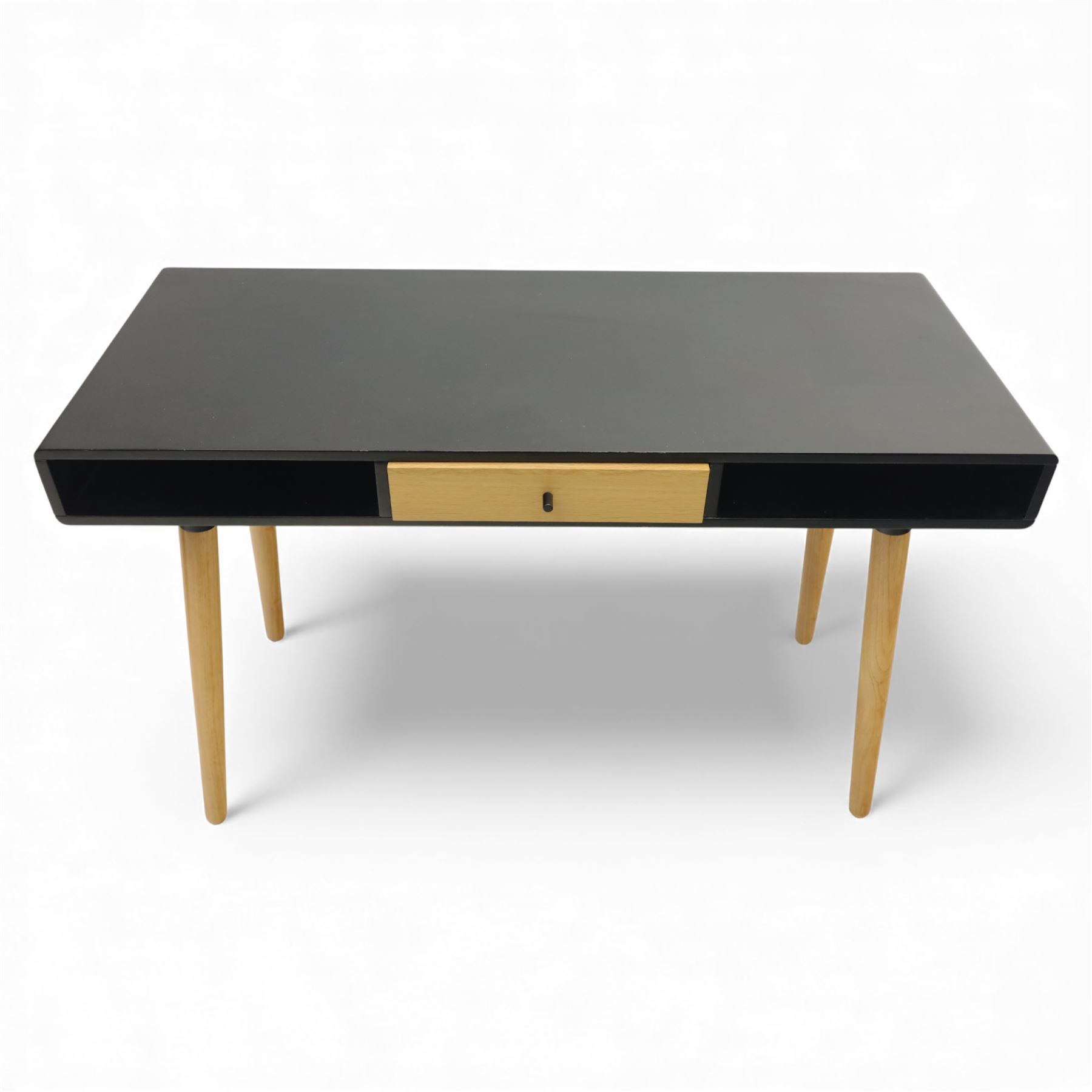 Modern black single drawer desk, black rectangular top above a single oak veneered drawer with black metal pull, flanked by two open shelves raised on tapering oak veneer legs (From floor to underside 64cm)