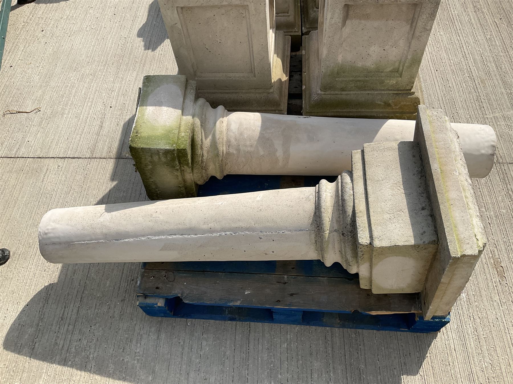 Set of four cast stone architectural columns, tapering form, on square plinth bases