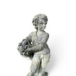 Weathered cast stone garden figure depicting a child holding a fruit basket