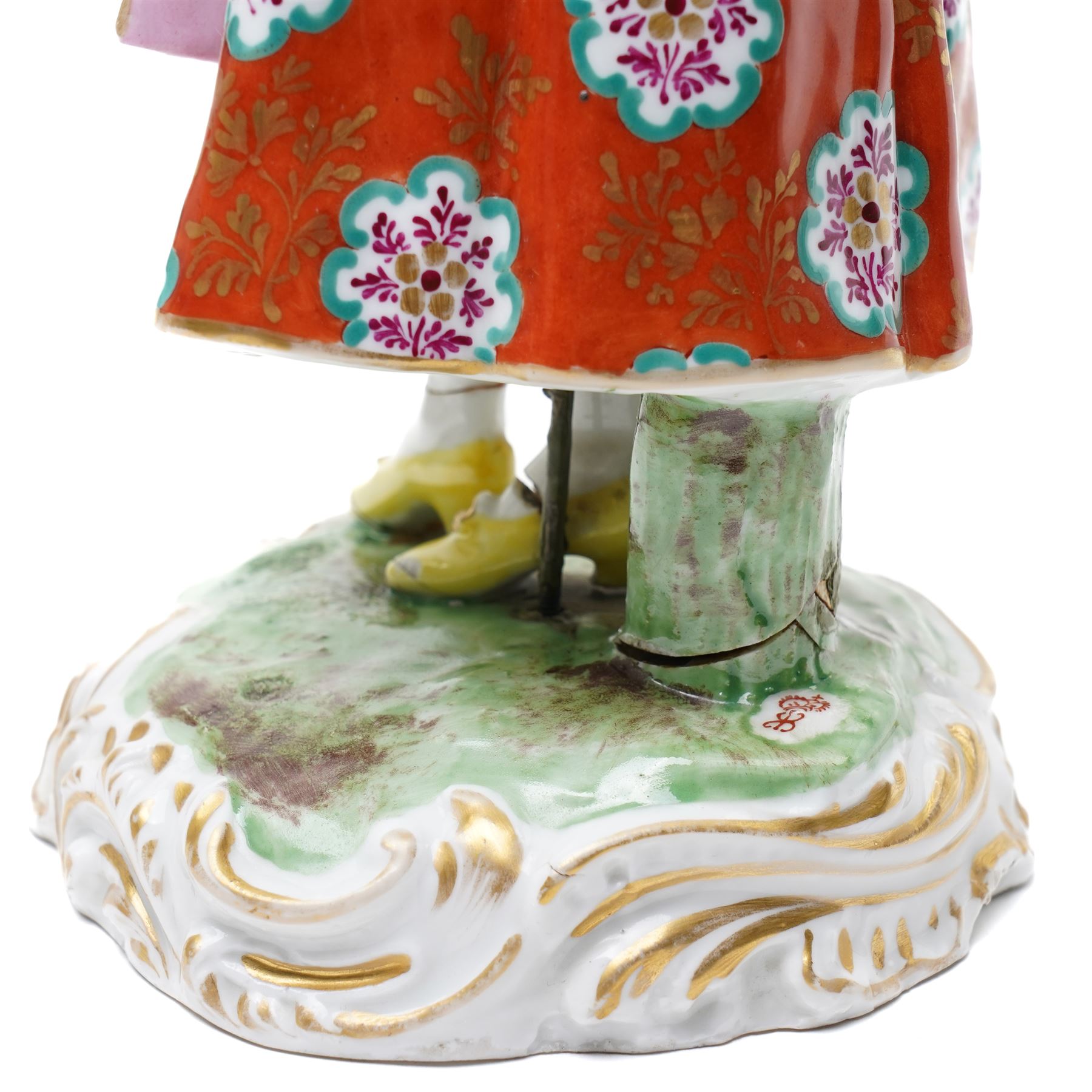 Pair of 19th century Samson of Paris figures of male and female itinerant milliners, each holding a basket with ribbons and flowers on rococo style gilt bases H33cm