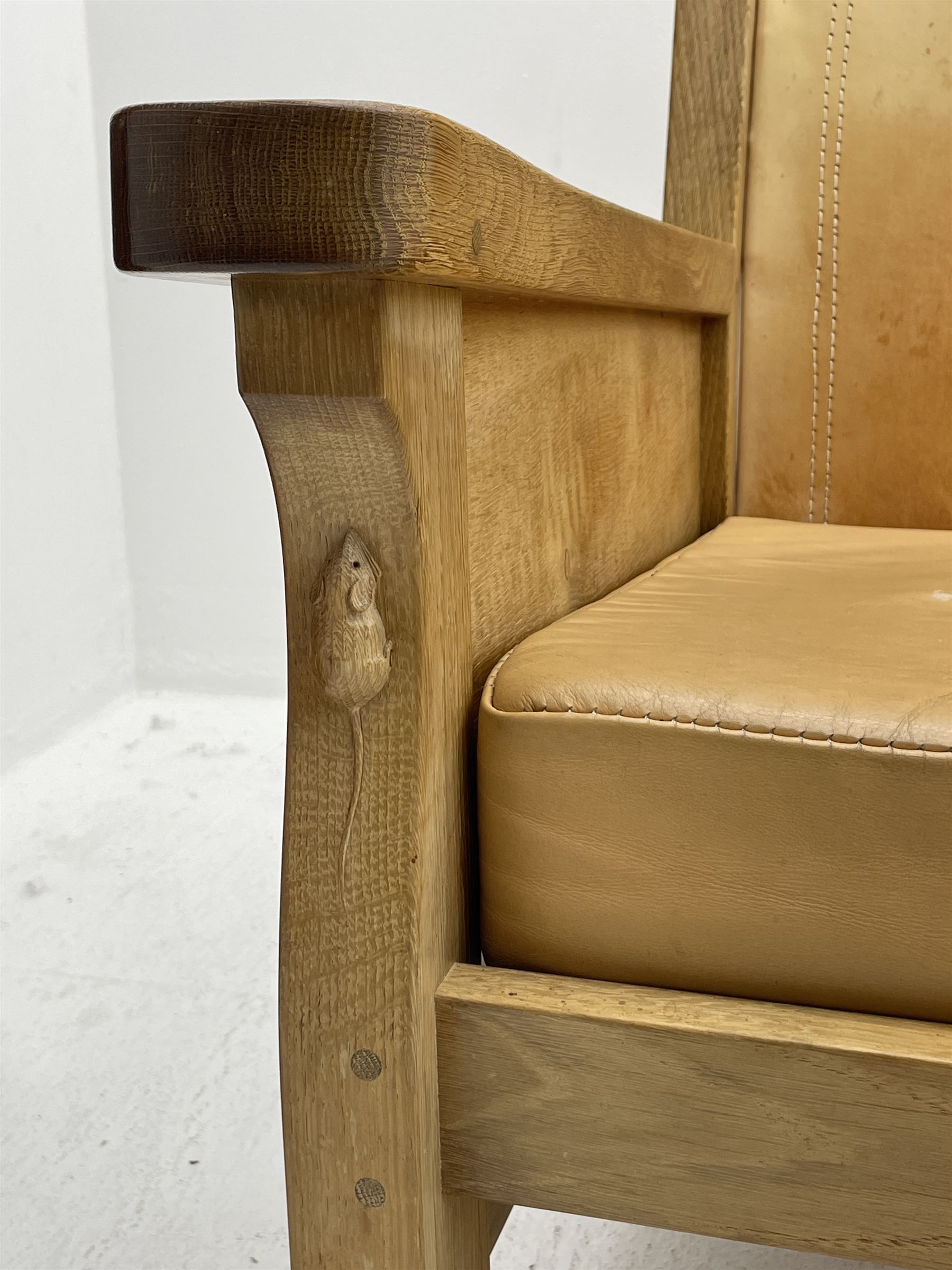 'Mouseman' oak smokers armchair, panelled sides, slung tan leather back and upholstered seat cushion, by Robert Thompson of Kilburn