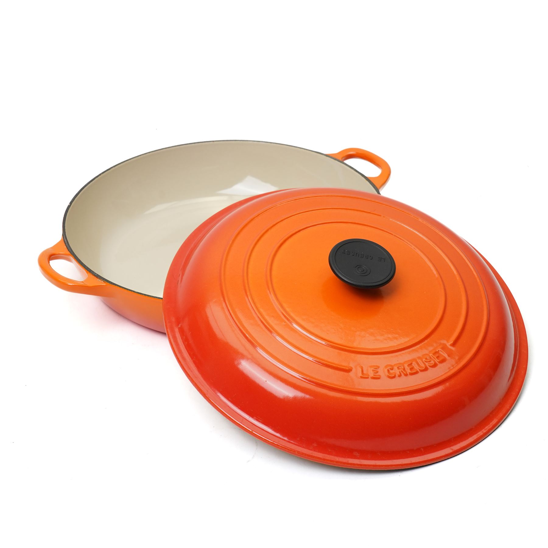 Le Creuset oval casserole dish and cover,  and another shallow example, in the Volcanic colourway