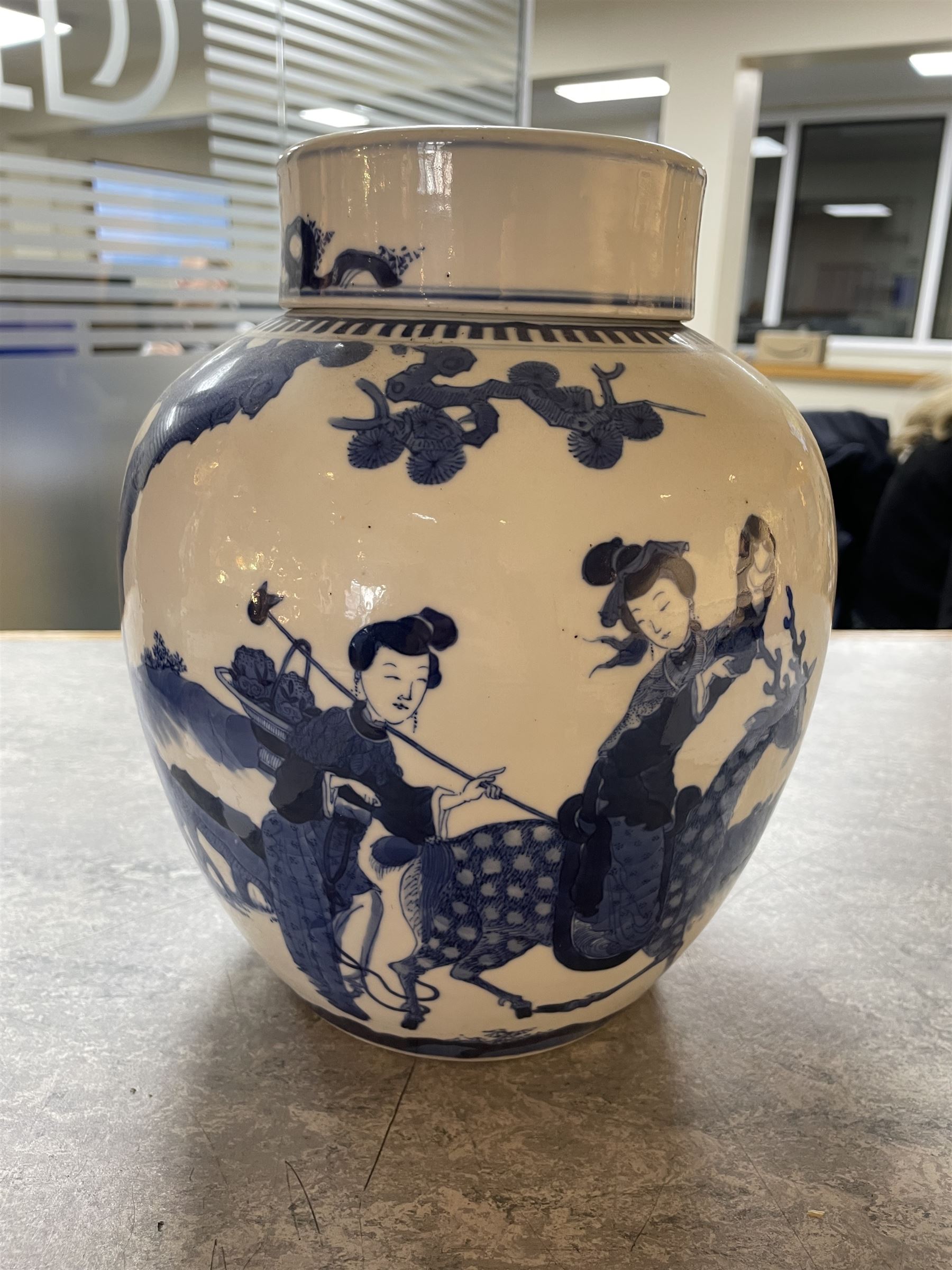Late 19th century Chinese blue and white ginger jar, of ovoid form with flat topped circular cover, the body decorated with a geisha on reindeer with attendant in a landscape setting, with apocryphal Kangxi mark beneath, H24cm