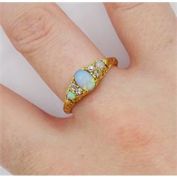 Edwardian 18ct gold three stone opal ring, with four diamond accents set between, Birmingham 1901