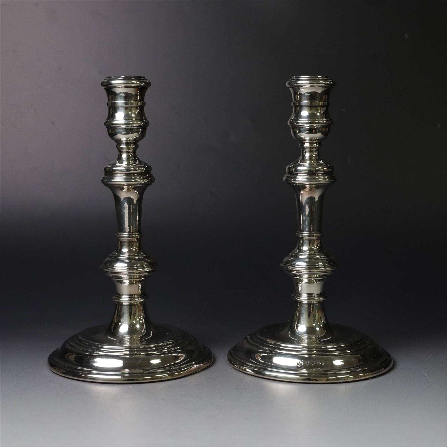 Pair of silver candlesticks, with knopped stems and upon spreading circular weighted bases, hallmarked William Comyns & Sons Ltd, London 1979, H20cm