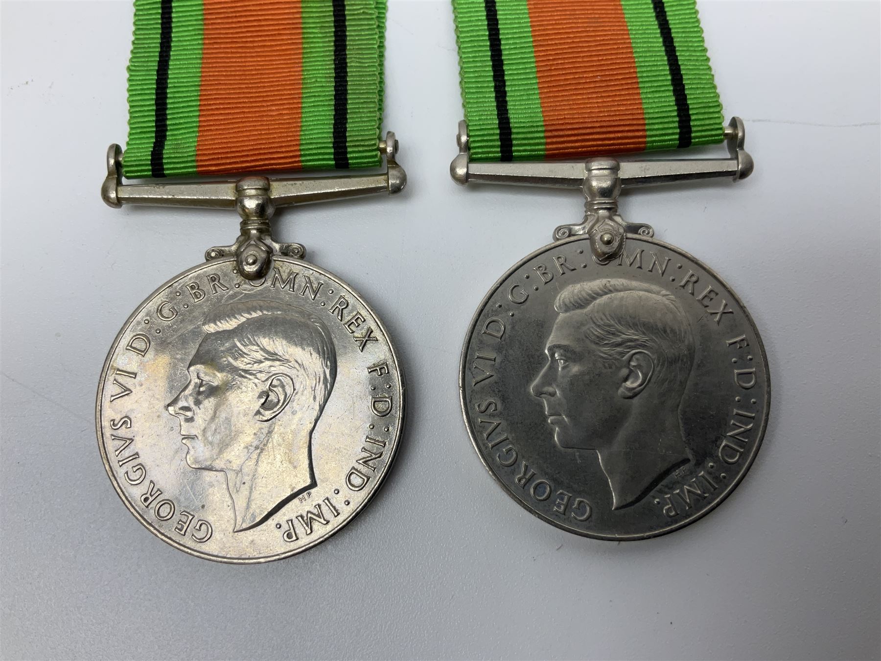 Ten WW2 medals comprising two 1939-1945 war medals, two Defence medals, two 1939-1945 Stars, two Africa Stars, France & Germany Star and Burma Star; together with bar of four miniature medals; all with ribbons