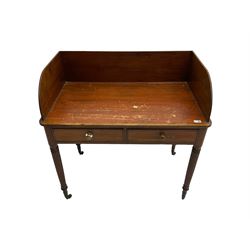 19th century mahogany desk, raised three-quarter gallery, fitted with two cock-beaded drawers, raisedon reeded supports with brass castors