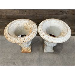 Pair of large Victorian design white painted cast iron campana shaped garden urns, egg and dart rim over a gadrooned underlobe, tapering column on square plinth base