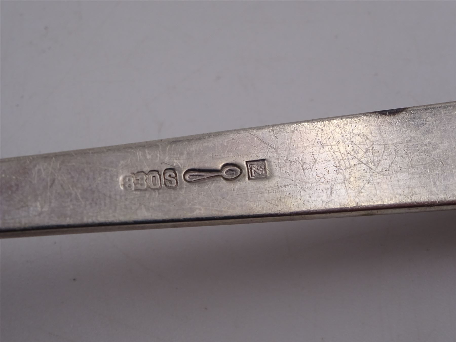 Collection of Norwegian silver flatware, including a set of six silver-gilt demitasse spoons, by David Andersen, stamped D-A 830s and a serving spoon, the pierced terminal with two doves, engraved with initial K and dated 10.09.32 verso, stamped 830s, etc